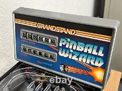 La traduction en français de ce titre est :    <br/> 
	'Flipper vintage Boxed Grandstand Pinball Wizard des années 1980 entièrement fonctionnel.'
